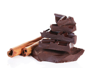 Cracked chocolate bar with spices isolated on white