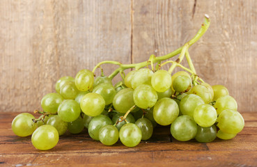 Green grape on wooden table on wooden background