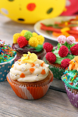 Delicious birthday cupcakes on table close-up