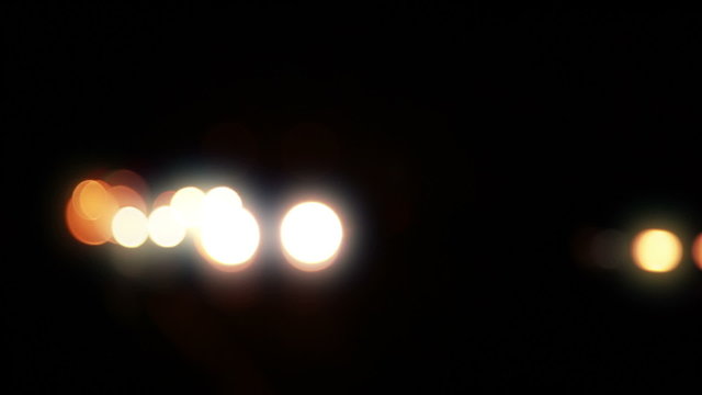 Car Headlights at Night. Defocused