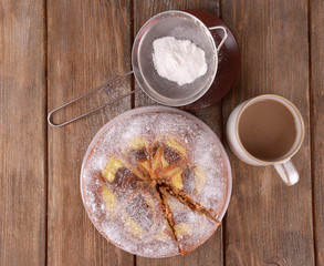 Delicious cake and cup of coffee on wooden table