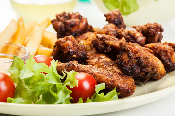 Chicken wings with fries french and spicy sauce