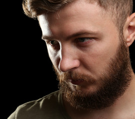 Obraz premium Portrait of handsome man with beard on black background
