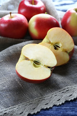 Juicy apples on wooden table, close-up