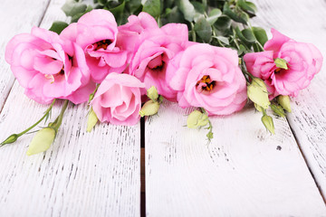 Beautiful eustoma flowers on wooden background