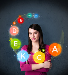 Young woman thinking with vitamins circulation around her head