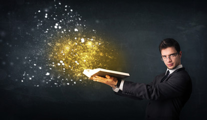 Young guy reading a magical book