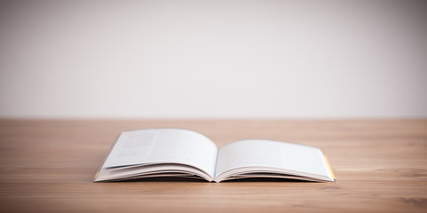 Open book on wooden deck