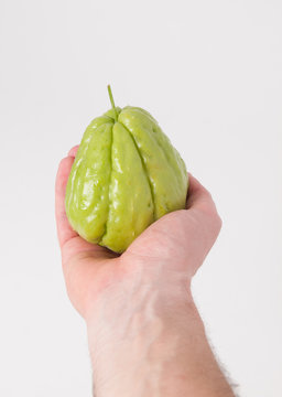 Chayote being held by a hand