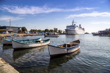 Fototapeta na wymiar Fishing boats and passenger ship