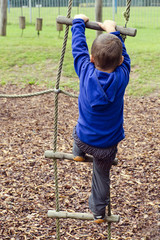 Child climbing ladder at playground