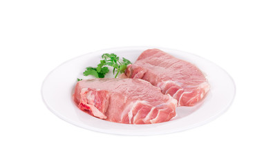 Fototapeta premium Raw pork steaks on plate.
