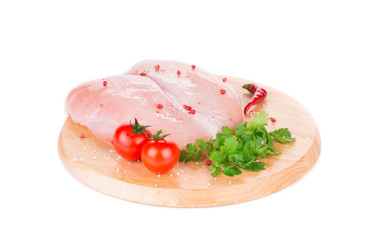Raw chicken fillet on platter.
