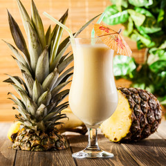 Pina Colada on wooden background garnished pineapple