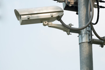 Security CCTV camera at pole in the park.