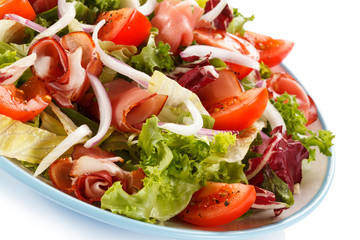 Vegetable salad with ham on white background
