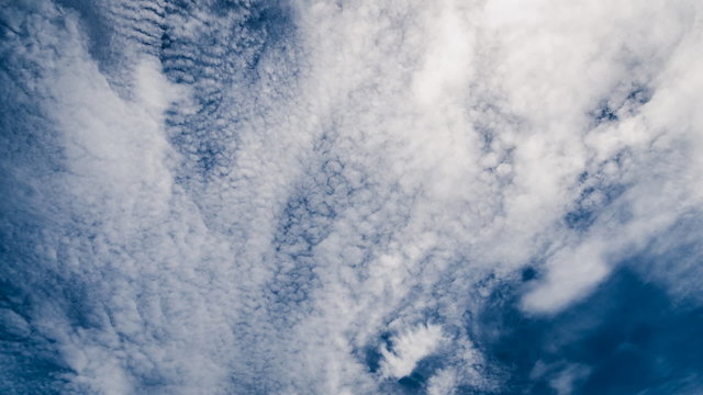 Beautiful cloudscape with large, building clouds and sunrise bre