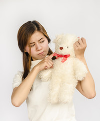Obraz premium asian teen holding a bear doll.