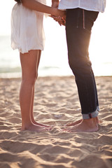 Couple's legs on the sand