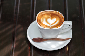 Cup of latte coffee on wooden