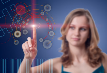 Young woman presses the button on the high-tech screen