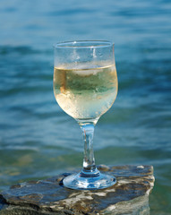 Glass of white wine by the coast