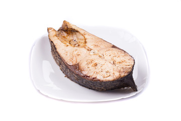 Fish steak on the round plate.