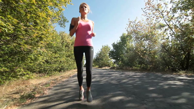 Woman fitness jogging workout on countryside road