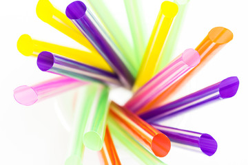 colorful cocktail straws in glass, top view