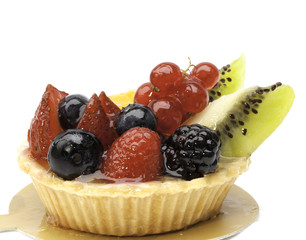 Custard pie with mixed fruits isolated on the white baclground