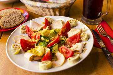 Gourmet salad with curry chicken stripes