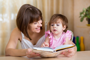 Fototapeta premium mother and kid daughter read a book