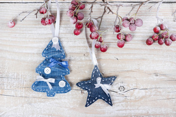 Christmas trees and stars on a branch with berries