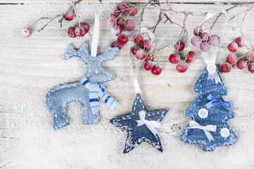 Christmas tree, reindeer and star on a branch with berries