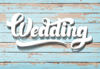 The word Wedding on a wooden background