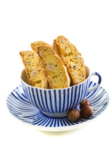 Biscotti in striped teacup.