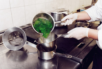 Chef is blanching fresh spinach