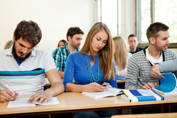 Students taking notes in a classroom