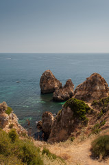 Fototapeta na wymiar Algarve coast, Portugal. Rocks in the shoreline and blue water