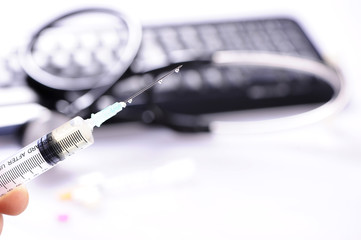 Syringe and stethoscope