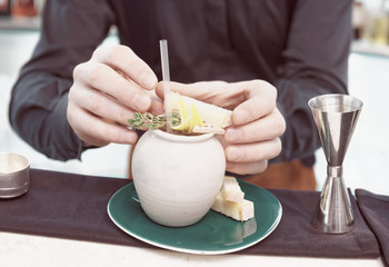 Bartender is serving cheese with cocktail