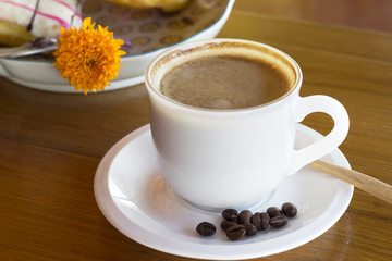 Coffee cup and bean on a wooden table