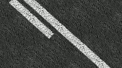 Animated close up of center line down a two way street. - Powered by Adobe