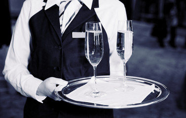 Female waiter with champagne flutes