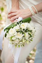 wedding bouquet is in the hands of fiancee