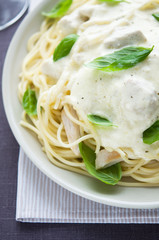 Pasta with chicken, creamy sauce and basil