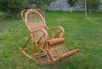 Wicker rocking-chair in the garden