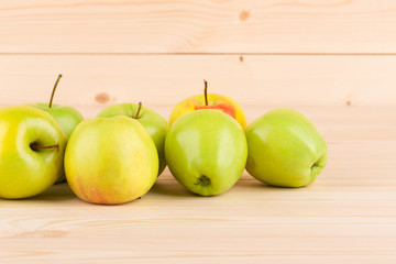 Fresh green apples on wood.