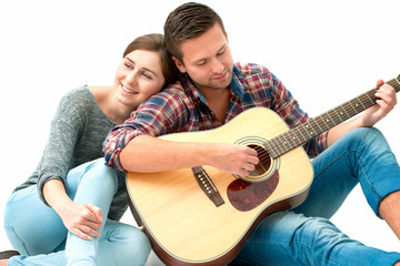 Young couple playing guitar