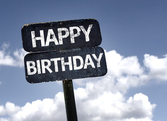 Happy Birthday sign with clouds and sky background